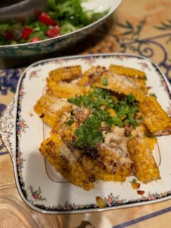 Here is the recipe for the Easy Elote Corn with Japanese twist. 🌽More like a finger food it is easy to eat;

2 ears of corn on the cob
Salad oil 2 tsp
Butter 20 g
Black pepper 
Grounded Parmesan cheese
Mirin (Japanese sweet sake ingredient for cooking) 2 tablespoons spoons
Soy sauce 4 teaspoons 
Small garlic clove grated 1 
Cilantro leaves to garnish 

1) wrap around the ears of corn with the glad wrap and microwave it for 3 minutes.  Leave it out till it cools down.
2)Cut the ears of corn into three horizontally.  Then cut each into four vertically.  Be careful it’s still a bit hard. 
3)Heat the frying pan and put the salad oil.  Place the corn kernel facing down and roast until golden brown. 
4) put in the Mirin, soy sauce and grated garlic. Mix it well.  Add the piece of butter and sprinkle black pepper. 
5)place on a plate and sprinkle generous amount of grated Parmesan cheese and sprinkle cilantro.

Give it a try!  Really good with 🍺! 
*If you don’t have Mirin you can use Sake or white wine. 
*2nd photo is the corn rice.  Easy rice cooker recipe. 

簡単エローテコーンみたいなとうもろこし🌽を食べやすくしてみたレシピ: フィンガーコーンかな？

とうもろこし　2本
サラダ油/米油　小さじ2くらい
バター　20g
パルメザンチーズ　たくさんお好みで
黒胡椒　お好みで
パクチ-または、イタリアンパセリ　　お好みで
みりん　　　大さじ2
醤油.  小さじ4
おろしにんにく小1かけ　　

1)とうもろこしは皮をむく、600Wの電子レンジに3分かける。粗熱が取れるまで放置する。
冷めたら、長さを三等分に切る。それを縦に四等分に切る。少し硬いので気をつけて。

2)フライパンに油を入れ熱し、(1)のとうもろこしの実の部分を下にしてフライパンに並べる。こんがり色が付くまで焼く。

3)みりん、醤油、にんにくを入れて、からめて香りをだす。バターも入れて、良い感じにまざったら、お皿に盛り、黒胡椒をふり、パルメザンチーズをたっぷりふりかける。パクチー/パセリを彩り良くのせる。

たくさん出来ますが、かなりお酒がすすむ美味しさてす。是非試してみてねー！😂
二枚目の写真は、コーンライスです。

#cornrecipe #コーンレシピ
#fingercornrecipe #フィンガーコーンレシピ